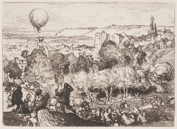 A crowd on a hillside looks toward the city with a hot air balloon floating by on the left.