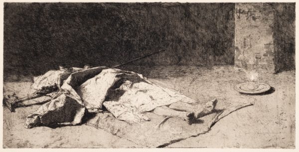 A figure lies in the street with the upper body covered with a stiff tarp and a long decorative staff or rifle over his chest. A candle is burning on at his feet.