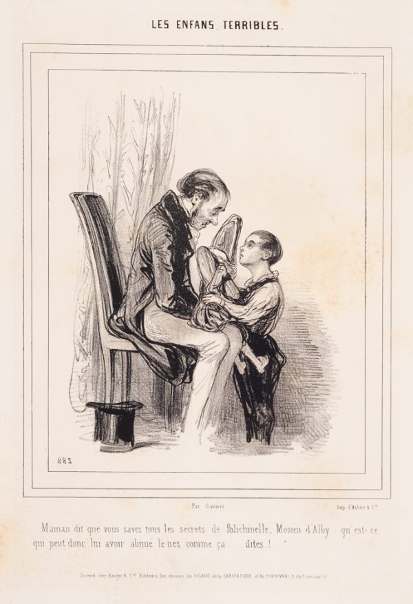 A boy holds a doll (?) on a seated man's lap.