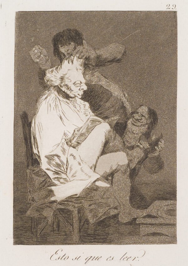 A man sits reading a newspaper while another does his hair.