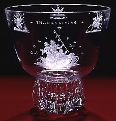 A clear punch bowl with engravings of 