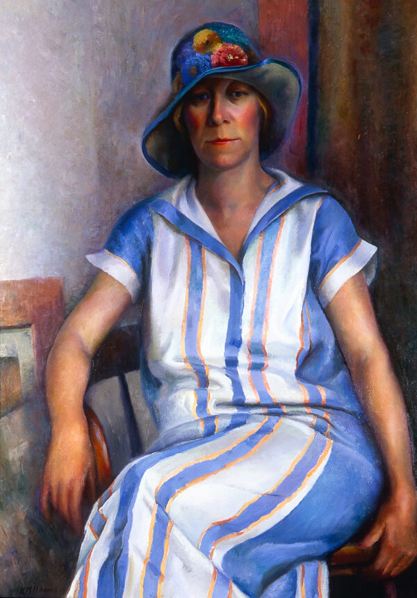A 3/4 view of a seated woman wearin a blue and white striped dress and blue hat.