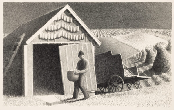A man carries a basket into a shed.
