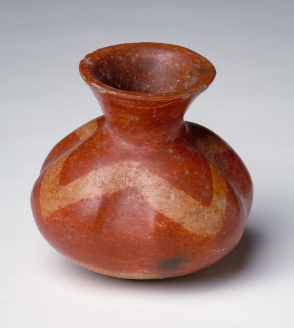 Bulbous shape with narrowed neck. Red with tan v-shaped decoration.