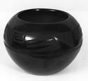 Black-on-black flat bottom bowl with incised and polished surface.