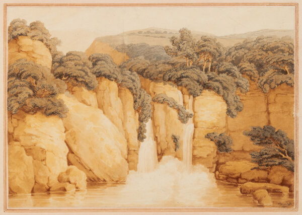 View of a waterfall over sandstone cliffs.