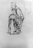 A seated woman with a coat draped over her knees.