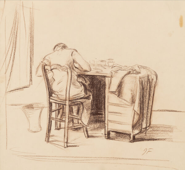 A woman is seen from the back at her desk with a cloth draped over the desk on her right.