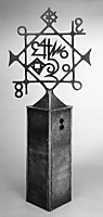 The number 8 is cut out of the pedestal and is in the lower corner of the sculpture.
43 and other symbols are at center and in the corners.