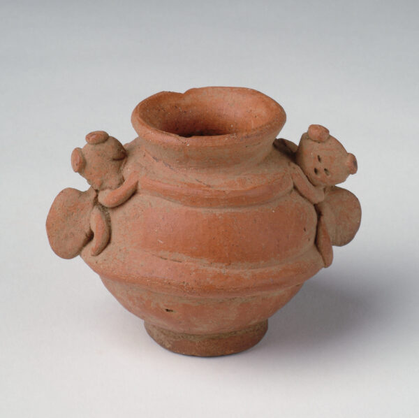Vessel with animal forms for handles.
