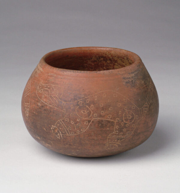 Red slip vessel with incised decoration.