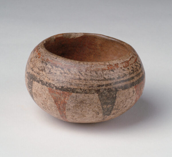 Bowl with tan body, red and black slip decoration.