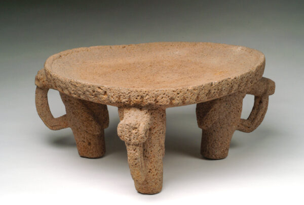 Tripod metate, flat top with animal legs.