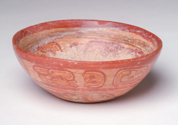 A flat bottom bowl with ran and red slip decoration.