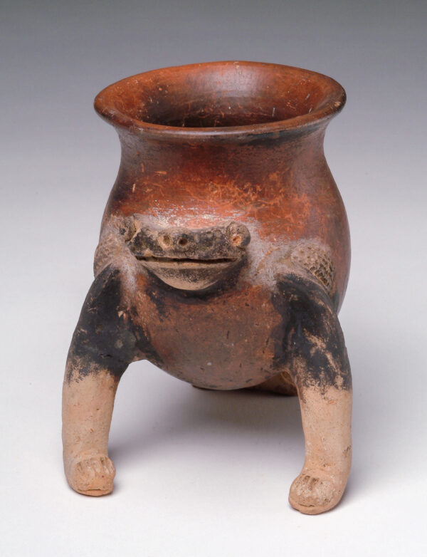 Tripod vessel with frog head with red, black and tan slip decoration.