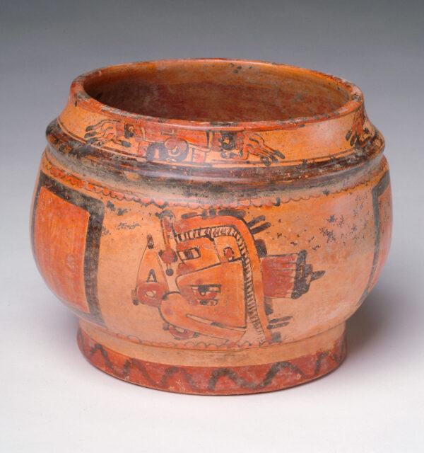 A footed bowl with a detailed deity on side.