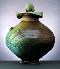A bulbous shaped green and brown jar with slab built cover. Soda fired porcelain