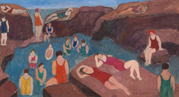 A small body of water, with multiple swimmers in the water, and on the surrounding large rocks.