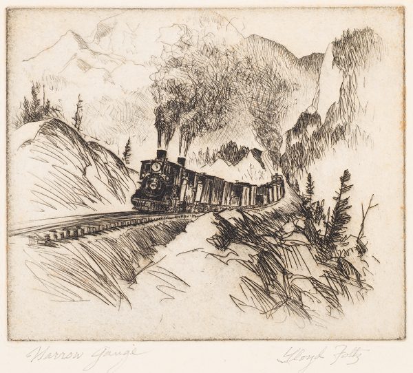 A train with three smoke stacks is coming down the rail with mountains in the background.