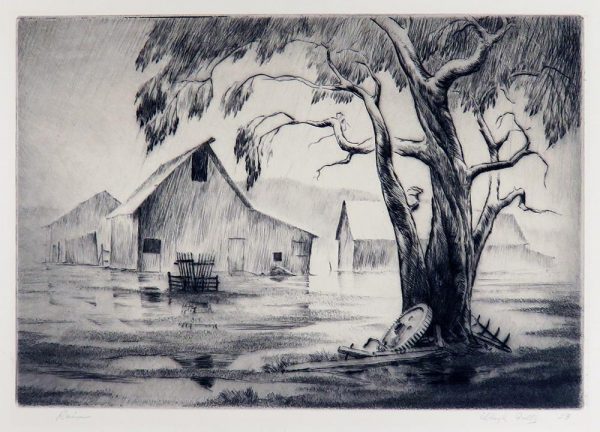 A farm scene of a tree in the foreground and barns in the background. It is raining and water is standing on the ground reflecting the scene.
