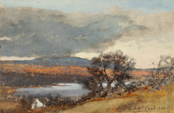 Bare trees beside the edge of a lake, clouds over distant hills.