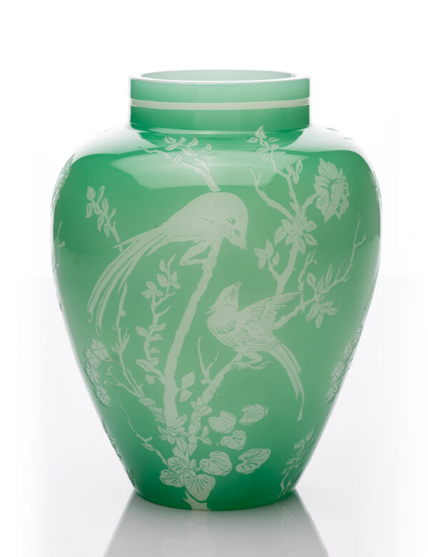 Urn-shaped vase with cylindrical neck. Neck with white band. Body with acid-etched 'Bird' design (Dimitroff, #2682, pg. 262) depicting two birds on flowering branches. Plain, flat base with polished pontil mark. Color: jade green over alabaster.