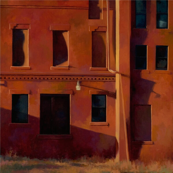 Red buildings with 12 windows, a drain, and a street light.