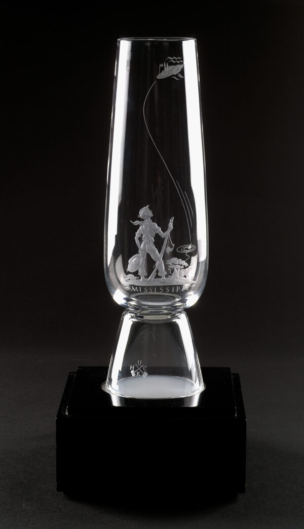 Vase with image of a boy holding a rifle in his right hand, a hat in his left hand. There is a rabbet in front of a tree/bush, and a fishing lure. The other side shows a paddle boat with flowing lines from the boat in a s-curve down the length of glass.