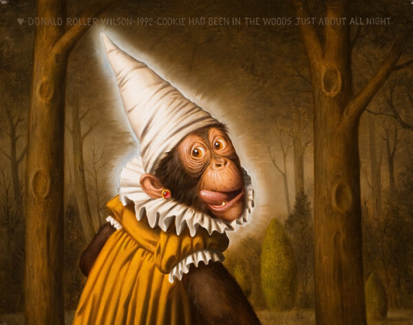 An orangutan is sticking out her tongue and is wearing a yellow robe with a white ruffled collar and sleeve edging. She is wearing a white dunce cap and an earring of red stone set in gold. There are trees in the background