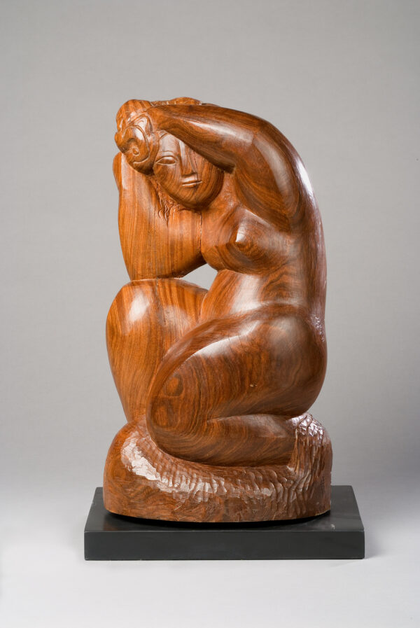 A sculpture of a woman kneeling with her hands holding her hair above her head.