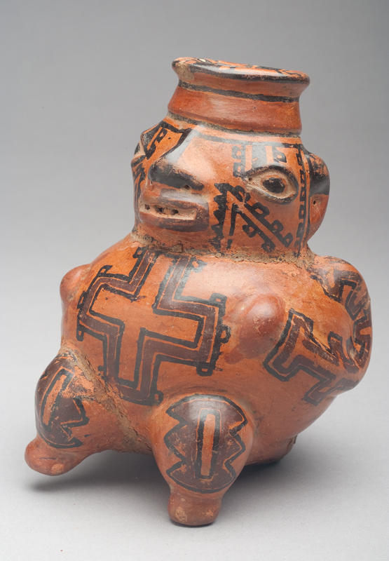 Terra cotta body with black and dark red ochre slip geometric designs on body.