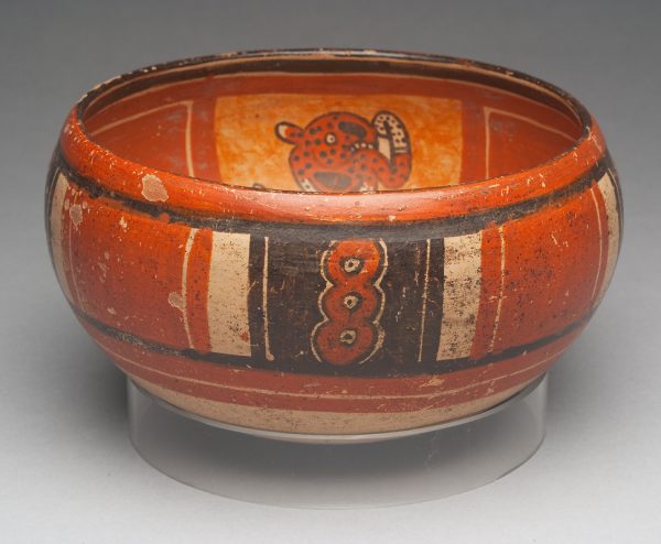 Buff bowl has red ochre and black slip designs. The outside is geometric and the inside is of three animal shapes.