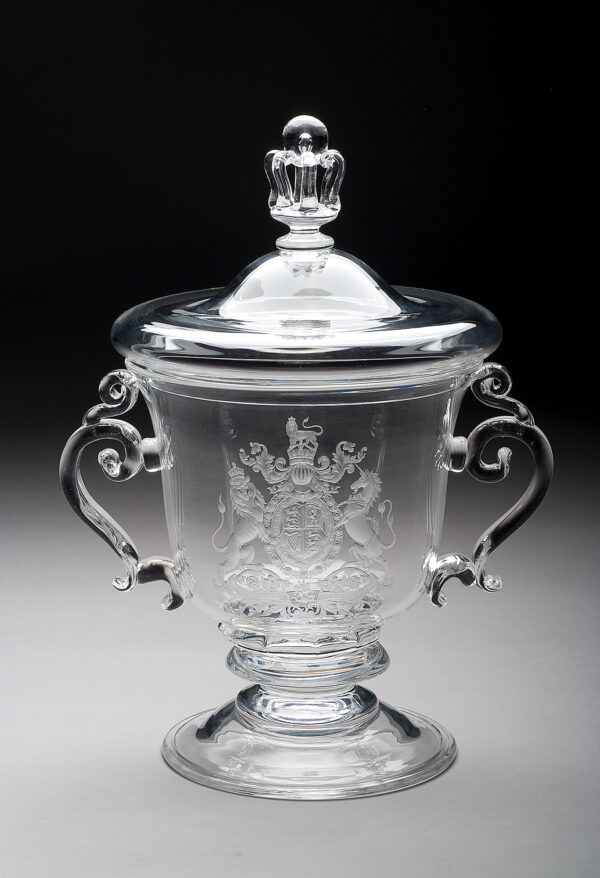 Clear scroll-handled, covered urn, engraved with the arms of Britain. The cup was designed by Steuben’s head of design, John Gates and presented to the British War Relief Society in commemoration of the Battle of Britain. Two cups were made and this is the original. ( The second cup, made at the same time was presented to John Gates when he retired in 1969 then given by Gates to The Corning Museum of Glass in 1977)