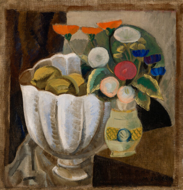 A still life consisting of a large white bowl of green fruit with a vase of several different flowers.