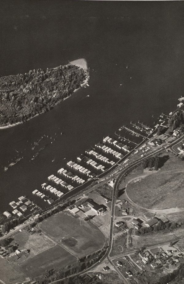 Harbor scene with piers of boat shelters.