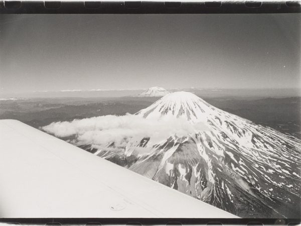 Mount St. Helens with wing of plane in lower left corner.