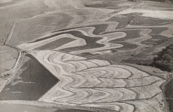 Plowed fields create a wavy pattern.