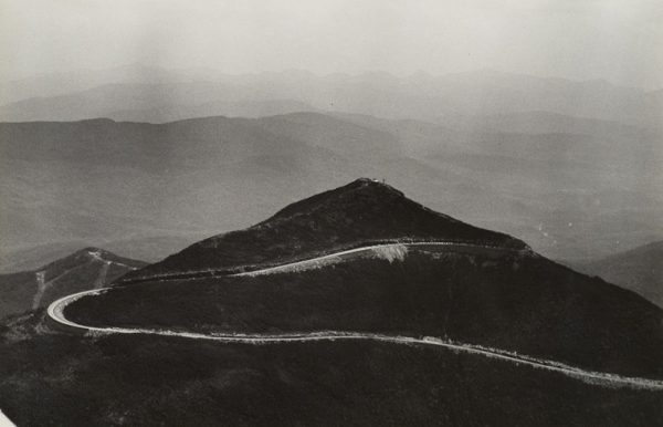 A road cutback up a dark mountain.