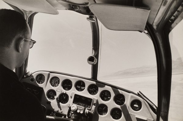 View of cockpit with pilot with Death Valley through windshield