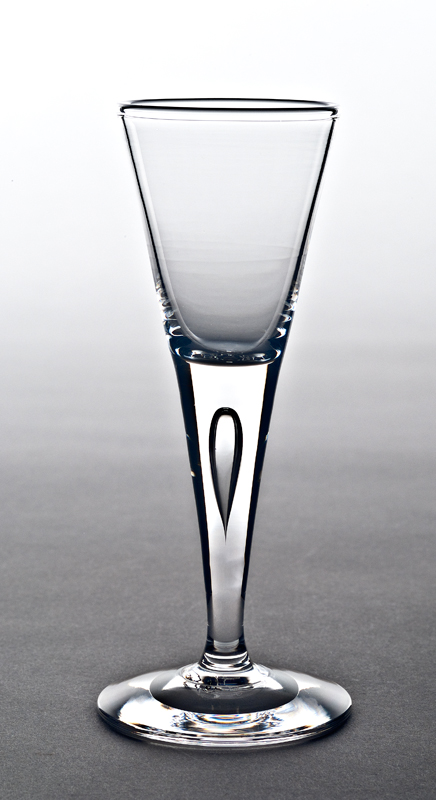 Small flute shaped glass with tear-drop air bubble in the stem.