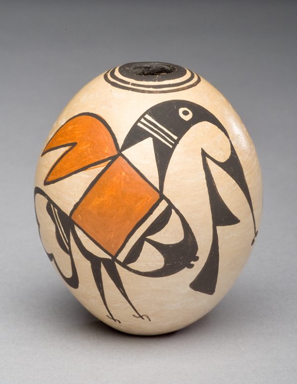 Egg shaped with at the top: three dark circles around a Ѕ” opening. The sides have two stylized birds.