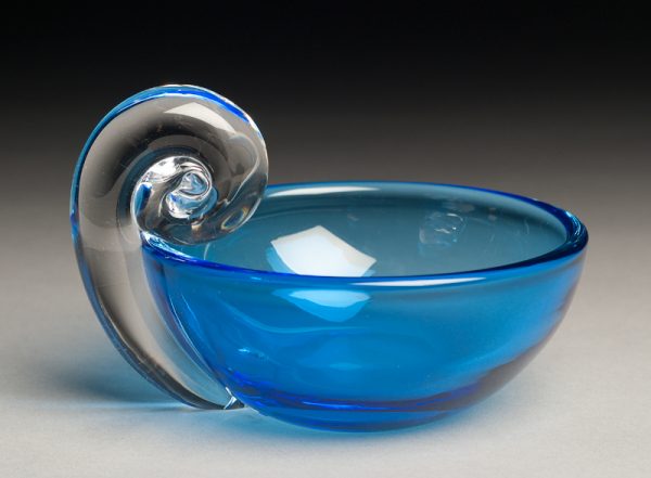 A blue bowl with a clear spiral handle.