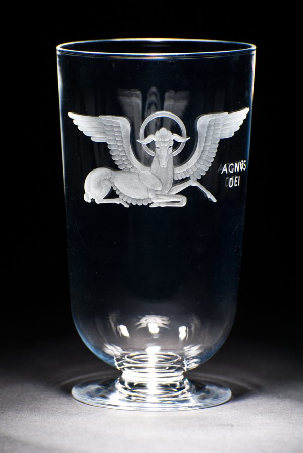 A clear glass vase with image of winged ox, the symbol of the Christian evangelist St. Luke. The vase was designed for the National Cathedral in Washington, D.C.
Agnus Dei (Lamb of God) refers to Jesus Christ in his role of the perfect sacrificial offering that atones for the sins of humanity in Christian theology.