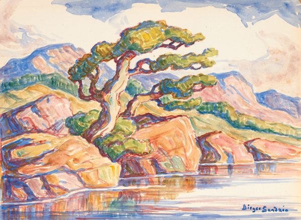 A lone tree at the edge of a body of water among red rocks with mountains in the distance.