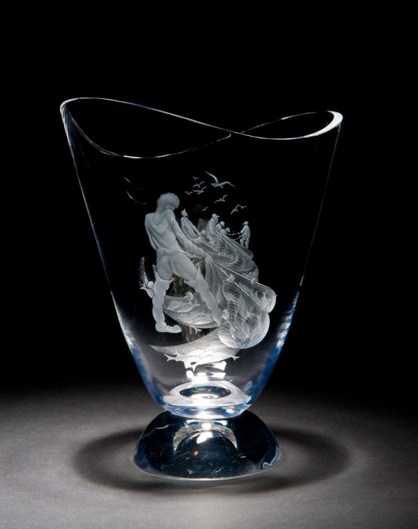 A vase, engraved with a scene of fishermen pulling on nets full of fish. There are seagulls in the sky above. The foot is a solid dome shape.