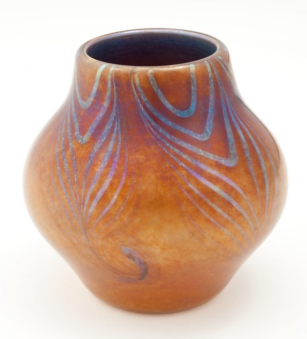 Blown vase decorated with a blue iridescent hooked feather design decending from the lip.