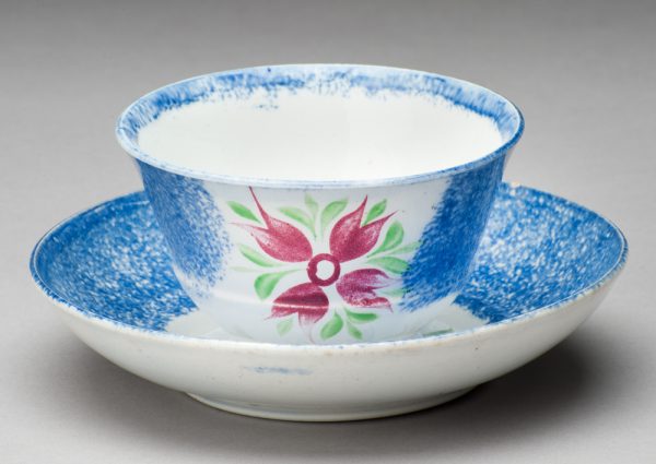 Spatterware cup in the Cluster of Buds pattern, blue with red flower/green leaves