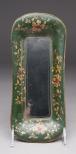 Tole painted metal tray with green background and gold and red flowers and foliage decoration on the sides.