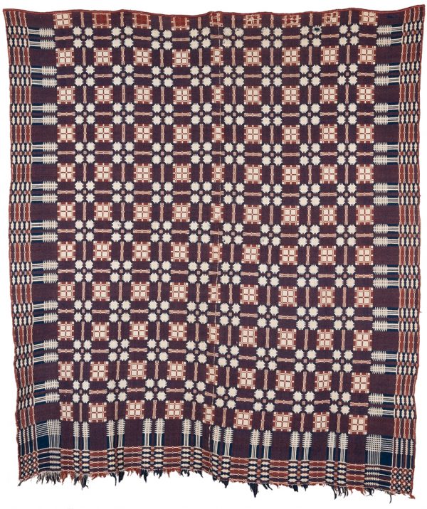 One side has cream background with blue and rust geometric design elements. The other side is brown background with blue, rust and cream designs.