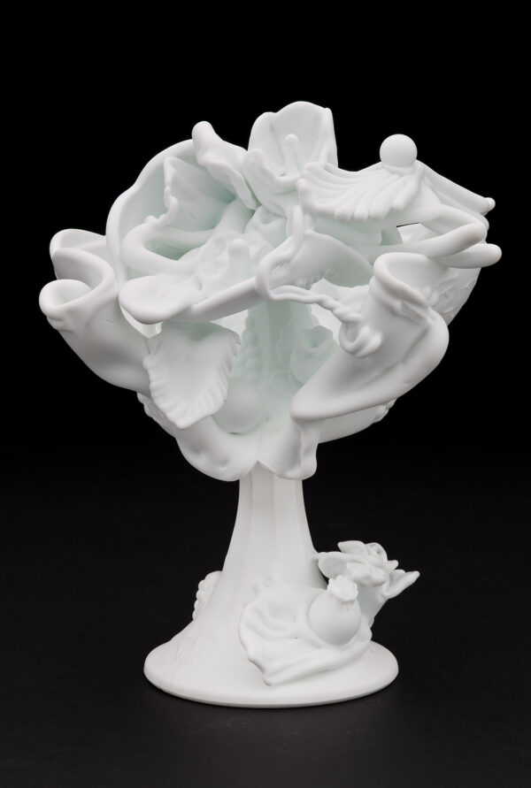 An all-white matte sculpture was made of American pressed milk glass that has been slumped and flame worked to a shape of a compote; with one side opened to a mass of organic shapes, that include flowers and leaves.